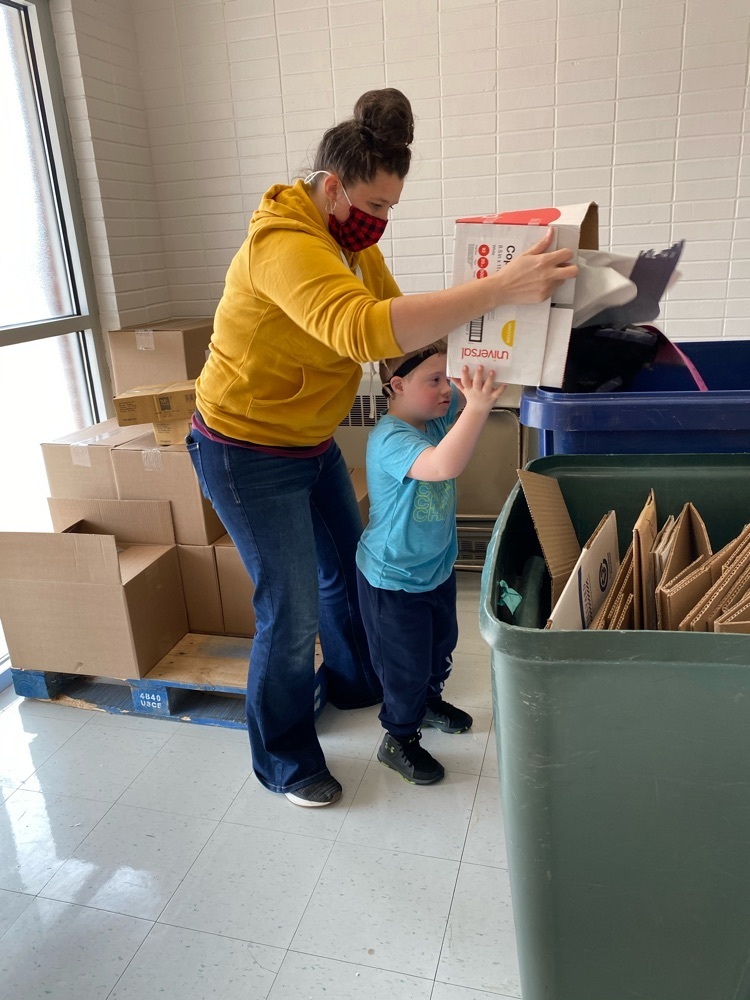 1st grade student helping with recycling 