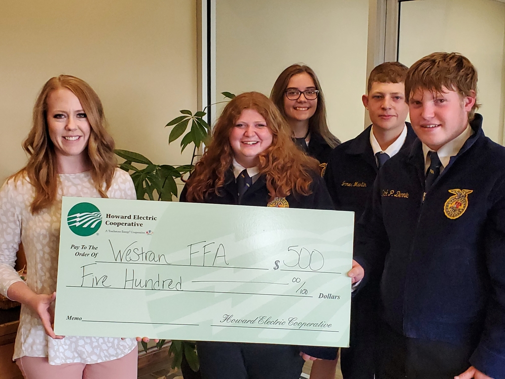Westran FFA members accepting a donation from Howard County Electric Cooperative 